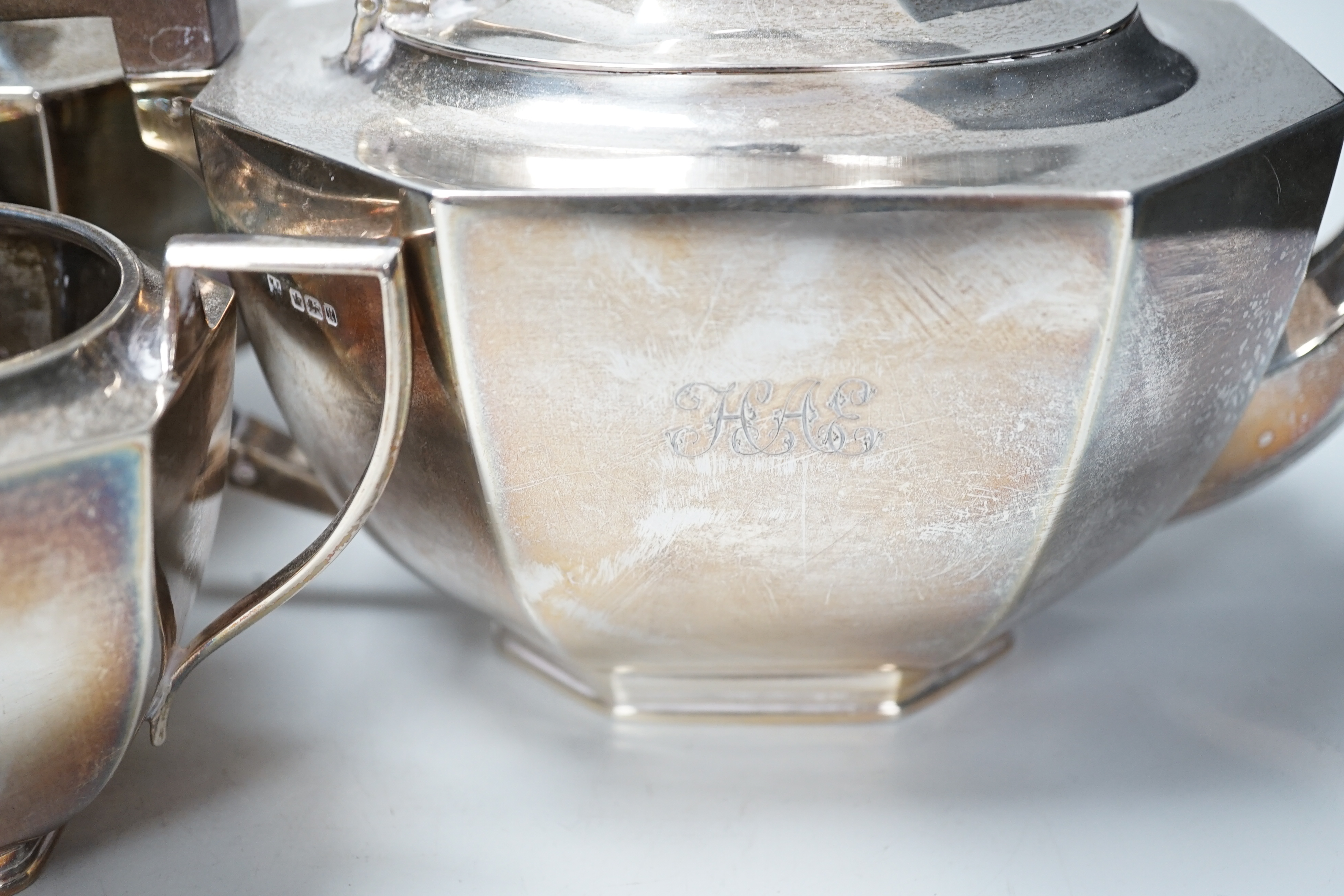 A George V panelled silver four piece tea and coffee service, Fordham & Faulkner, Sheffield, 1911 and a similar hot water pot, Hawksworth, Eyre & Co Ltd, London, 1912, gross weight 79.3oz.